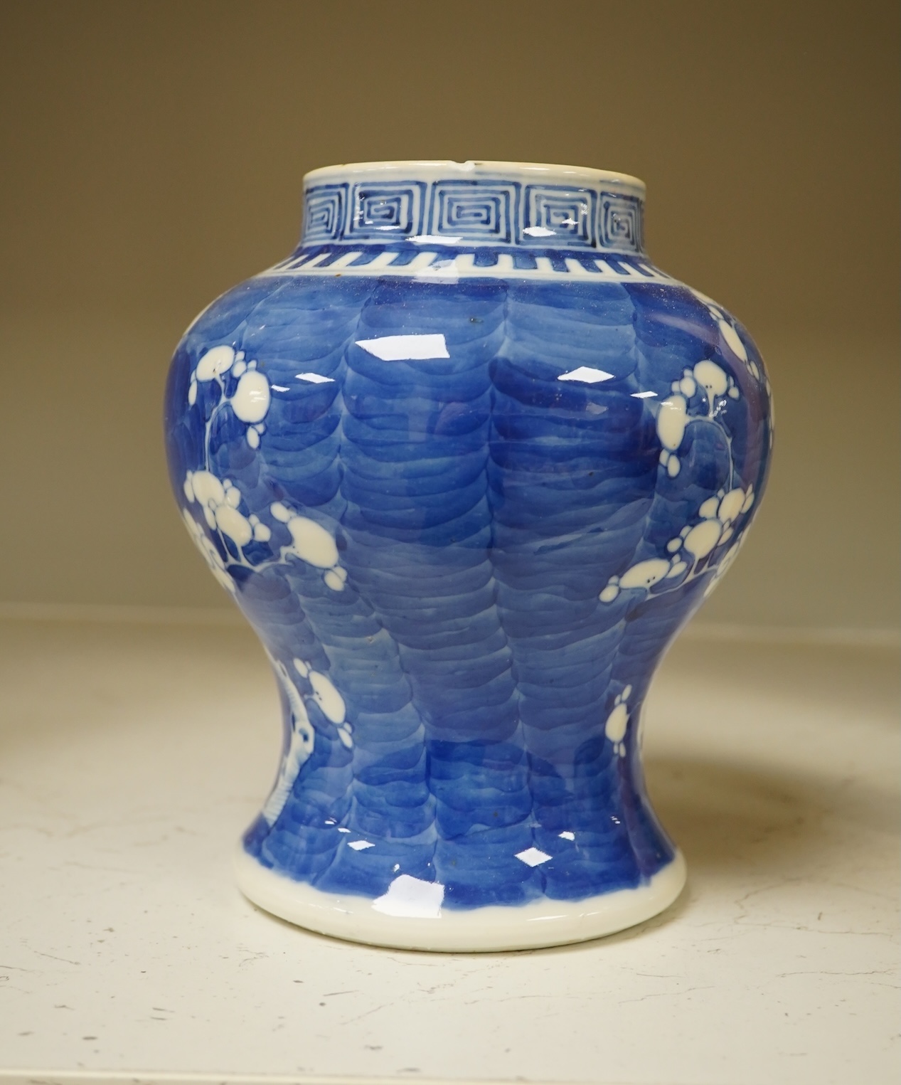 A 19th century Chinese blue and white 'prunus' vase, a Chinese green glazed jar, a Japanese vase and two dishes and two Canton famille rose plates (7). Condition - fair to good